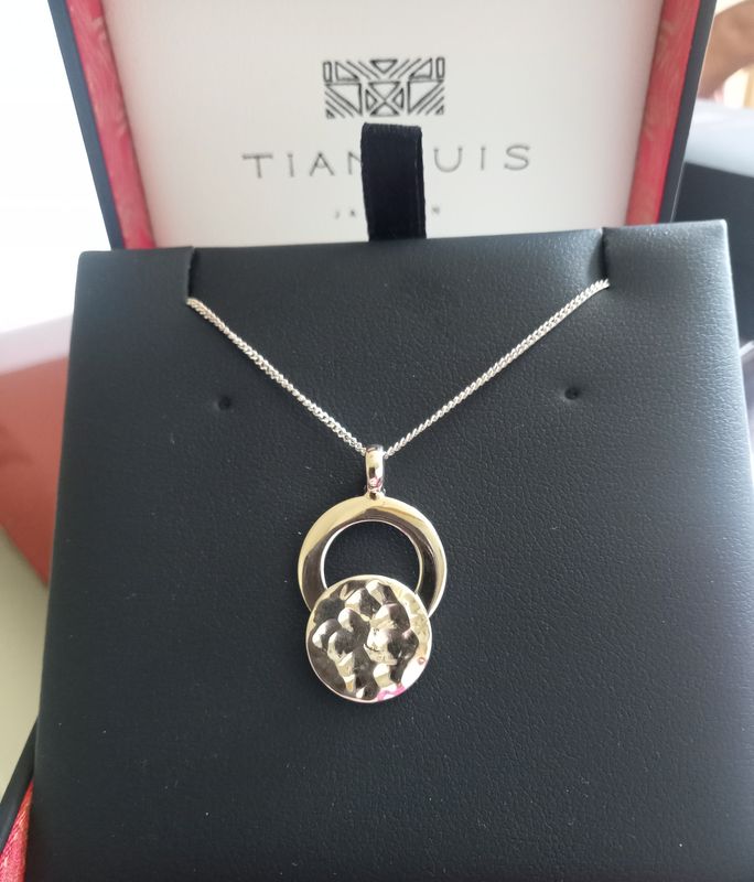 Open shiny circle and closed hammered circle pendant