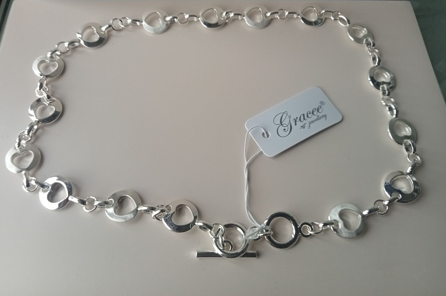 Chunky necklace with oval link with heart inside