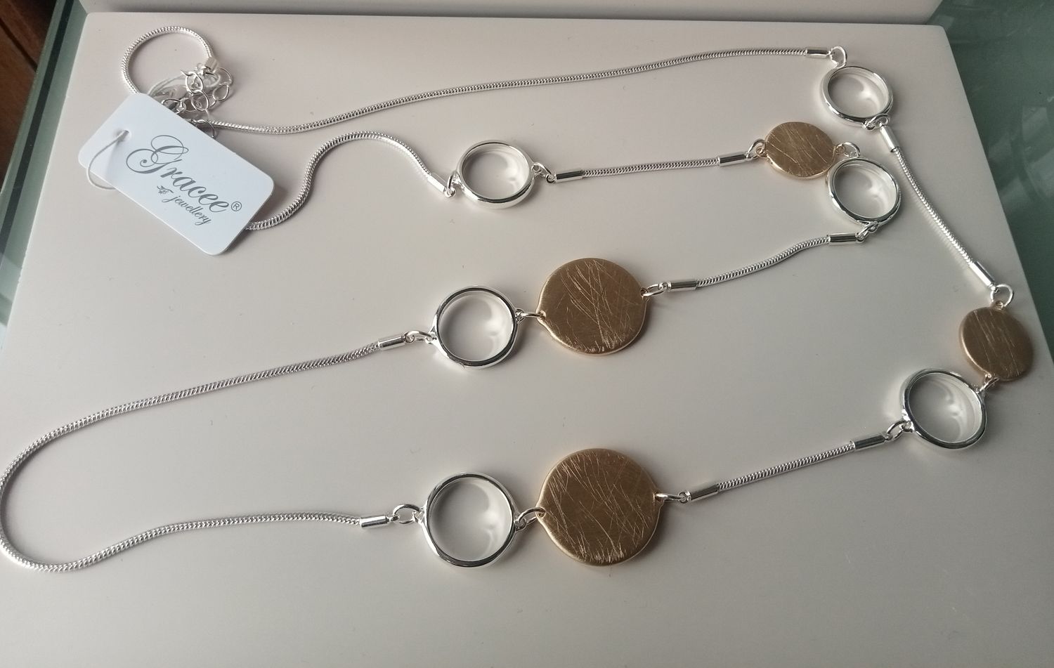 Long silver and gold tone necklace with circles
