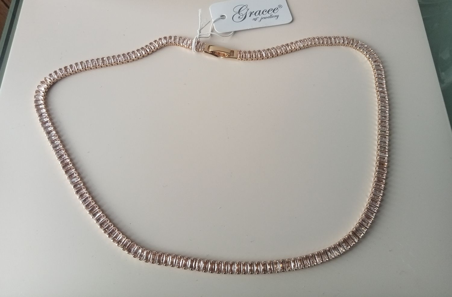 Gold tone baguette cut clear stone necklace