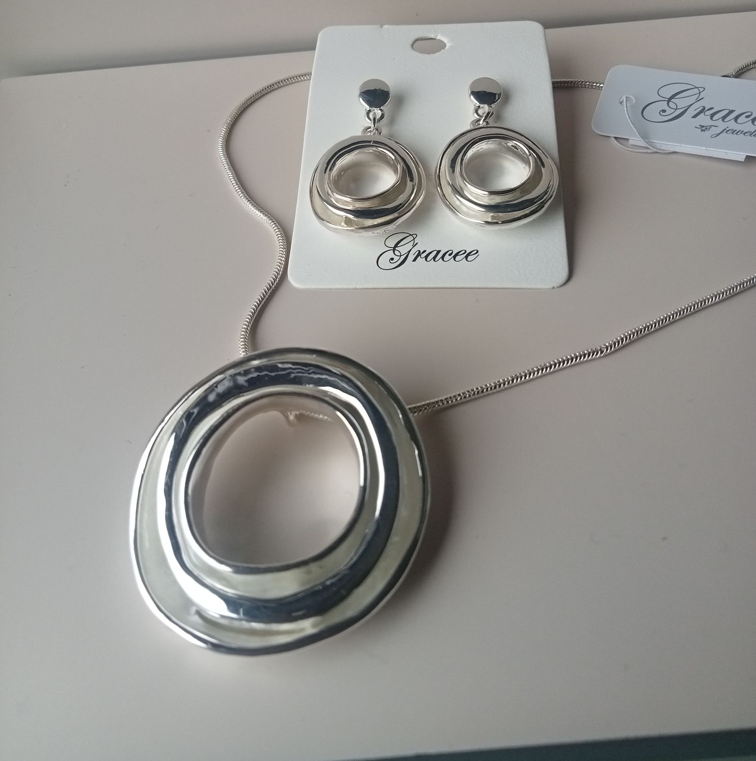 Silver tone large circle drop earrings