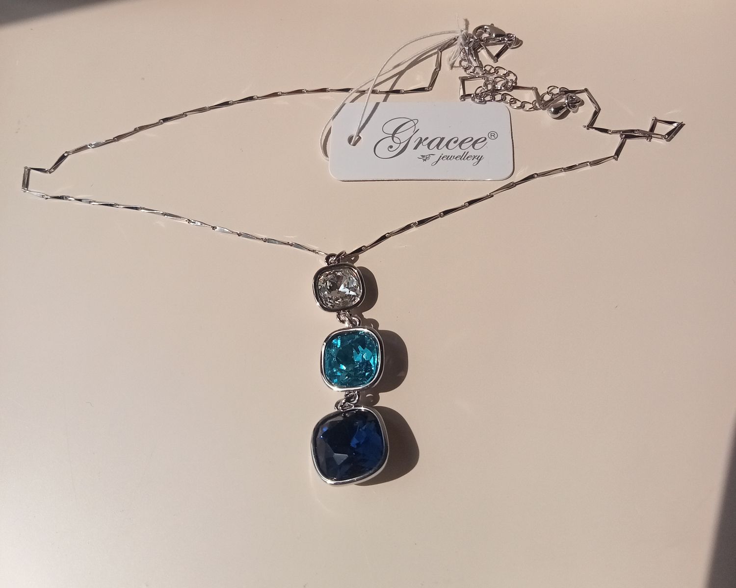 3 stone blue and clear stone pendant