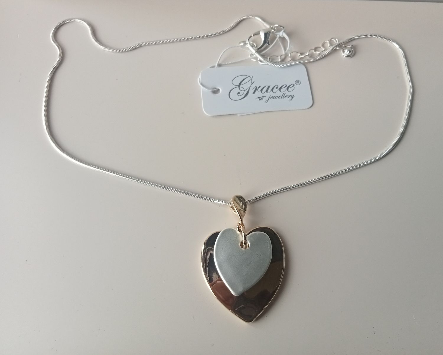 Gold tone and silver tone heart pendant
