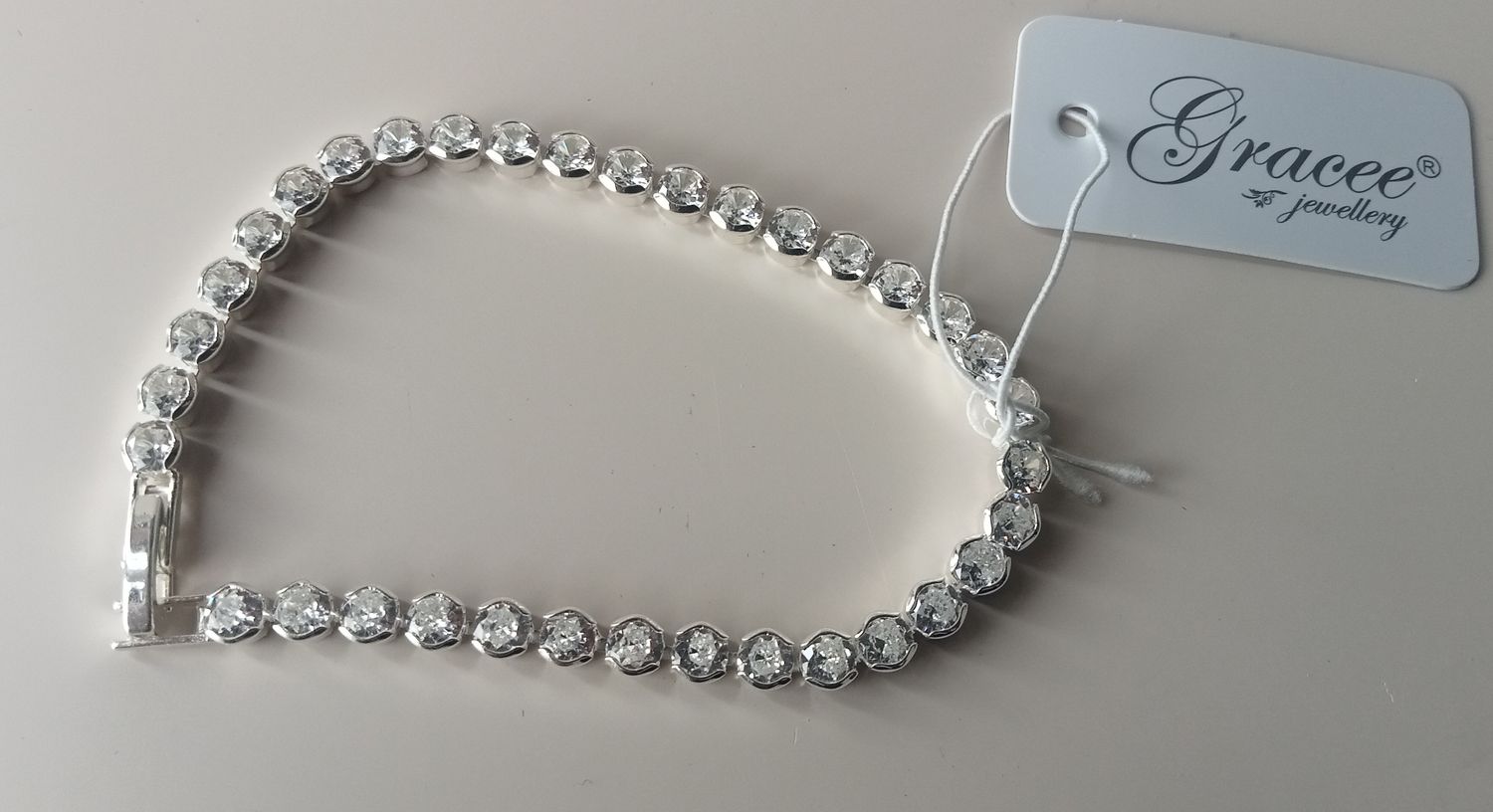 Silver tone tennis bracelet with clear stones