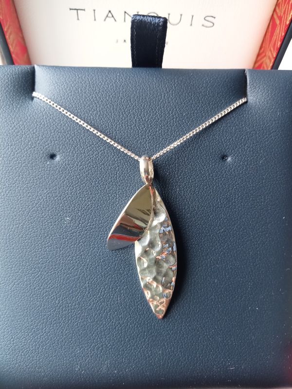 Oval hammered and plain silver pendant