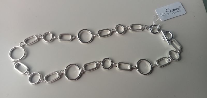 Silver tone T bar necklace with circles and rectangles