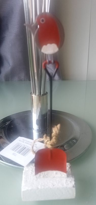 Robin perched on top a spade