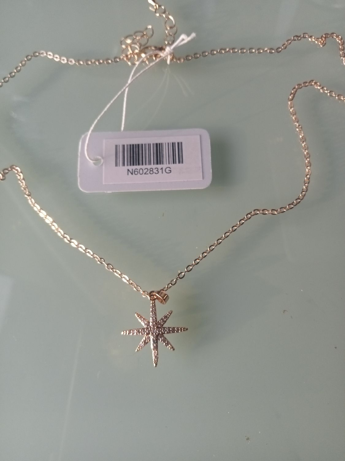 Gold tone star pendant