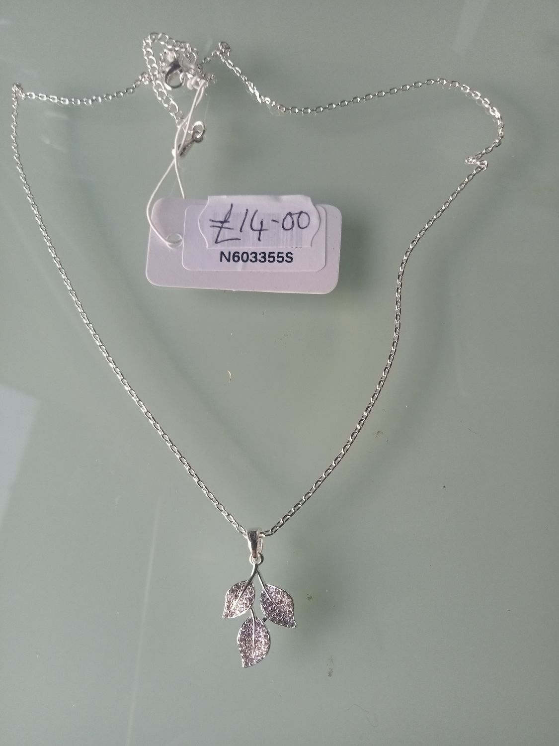 Silver tone three leaf pendant on fine chain