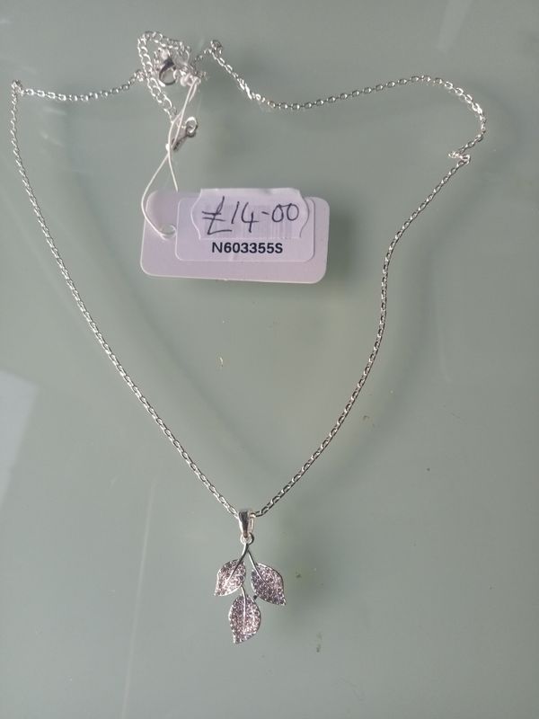 Silver tone three leaf pendant on fine chain