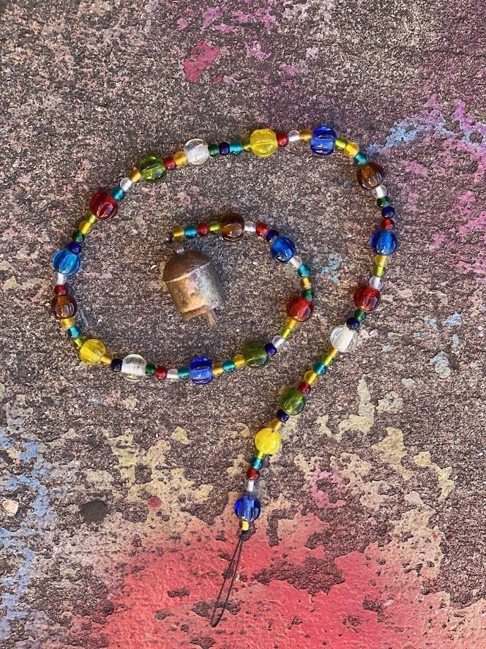A Mix Of Colors Glass Beads And Bell