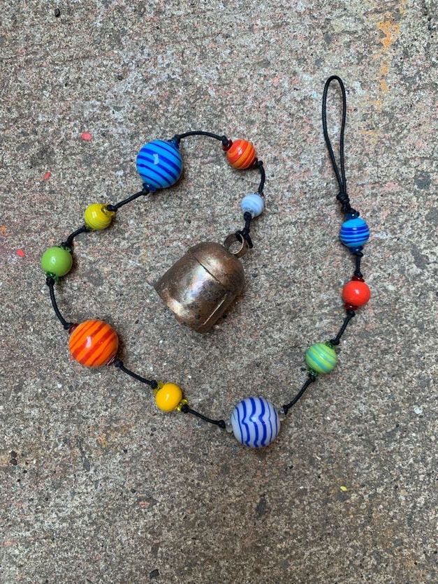 Round Striped Strand Of Beads And Bell