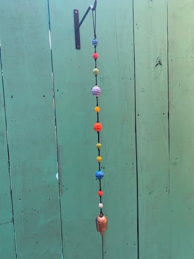 Round Striped Strand Of Beads And Bell