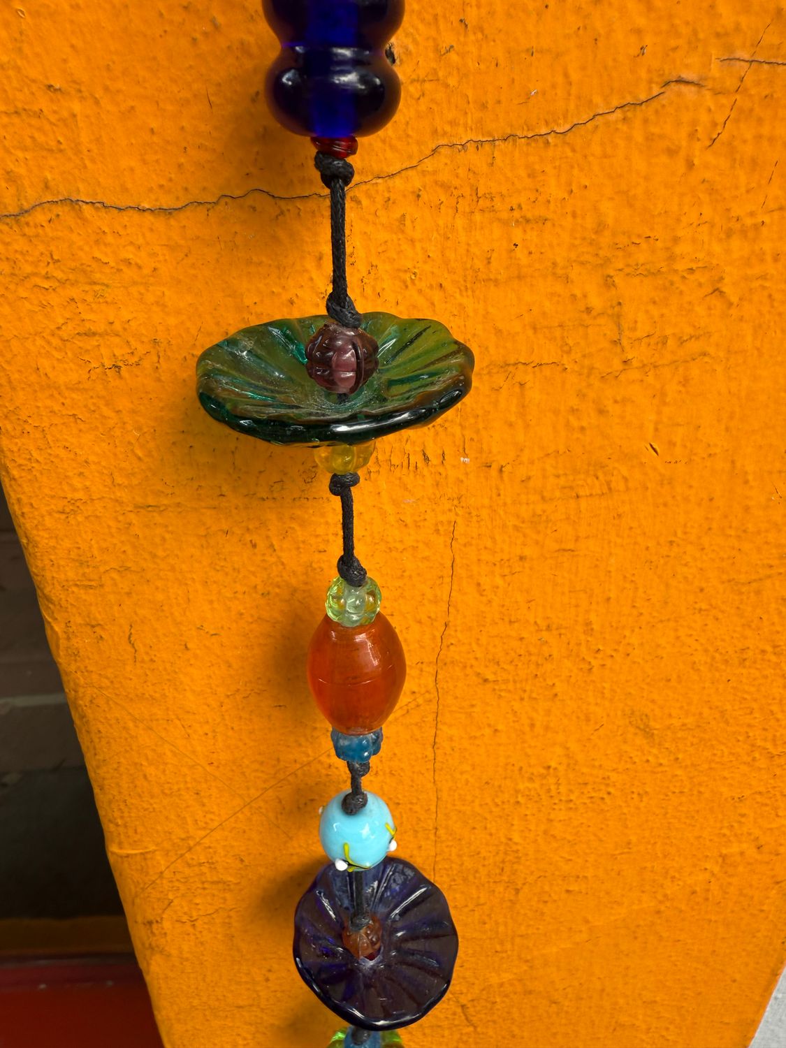A Field Of Flowers Strand Of Beads And Bell