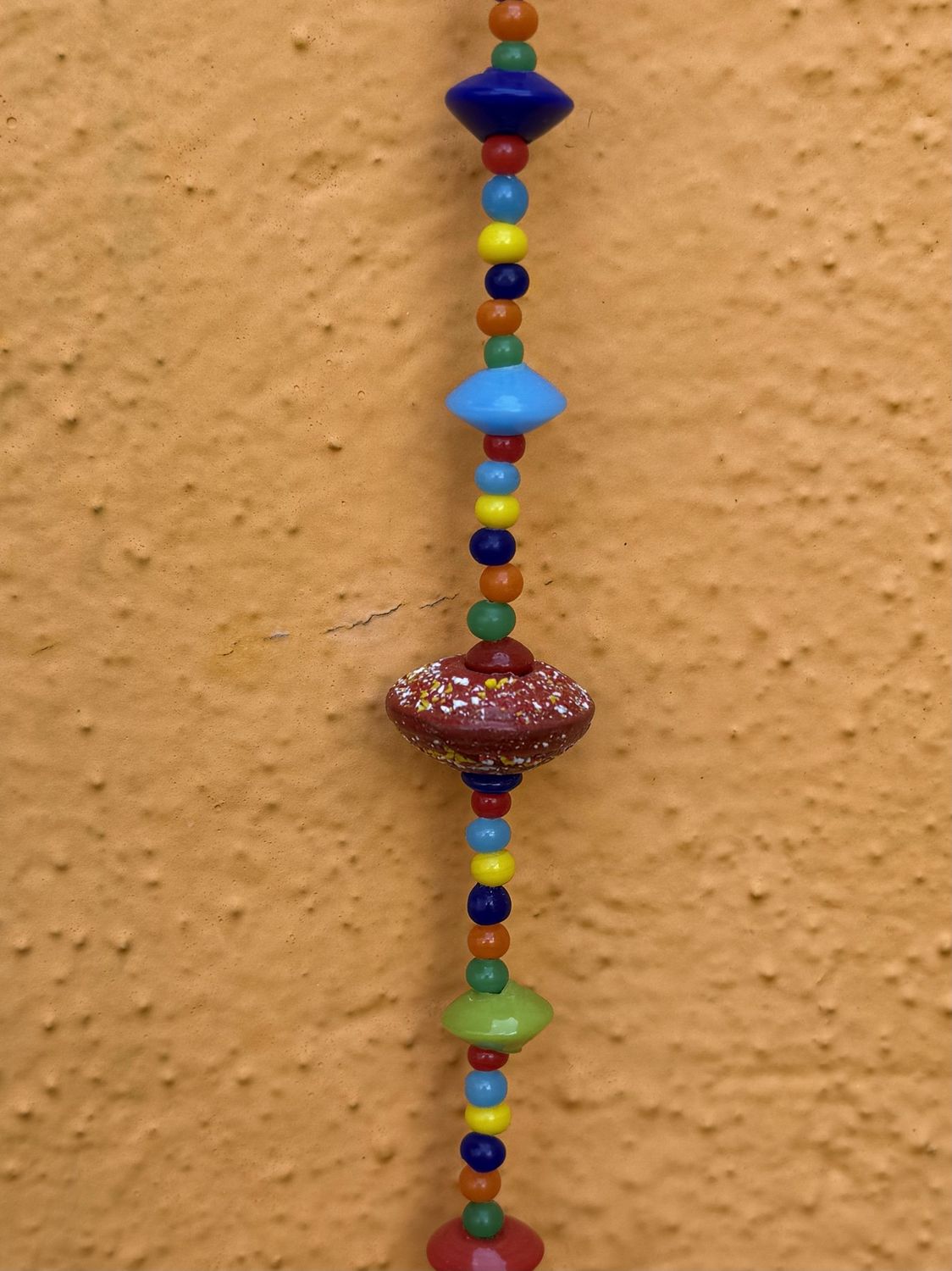 Where Colors Meet Strand Of Beads And Bell