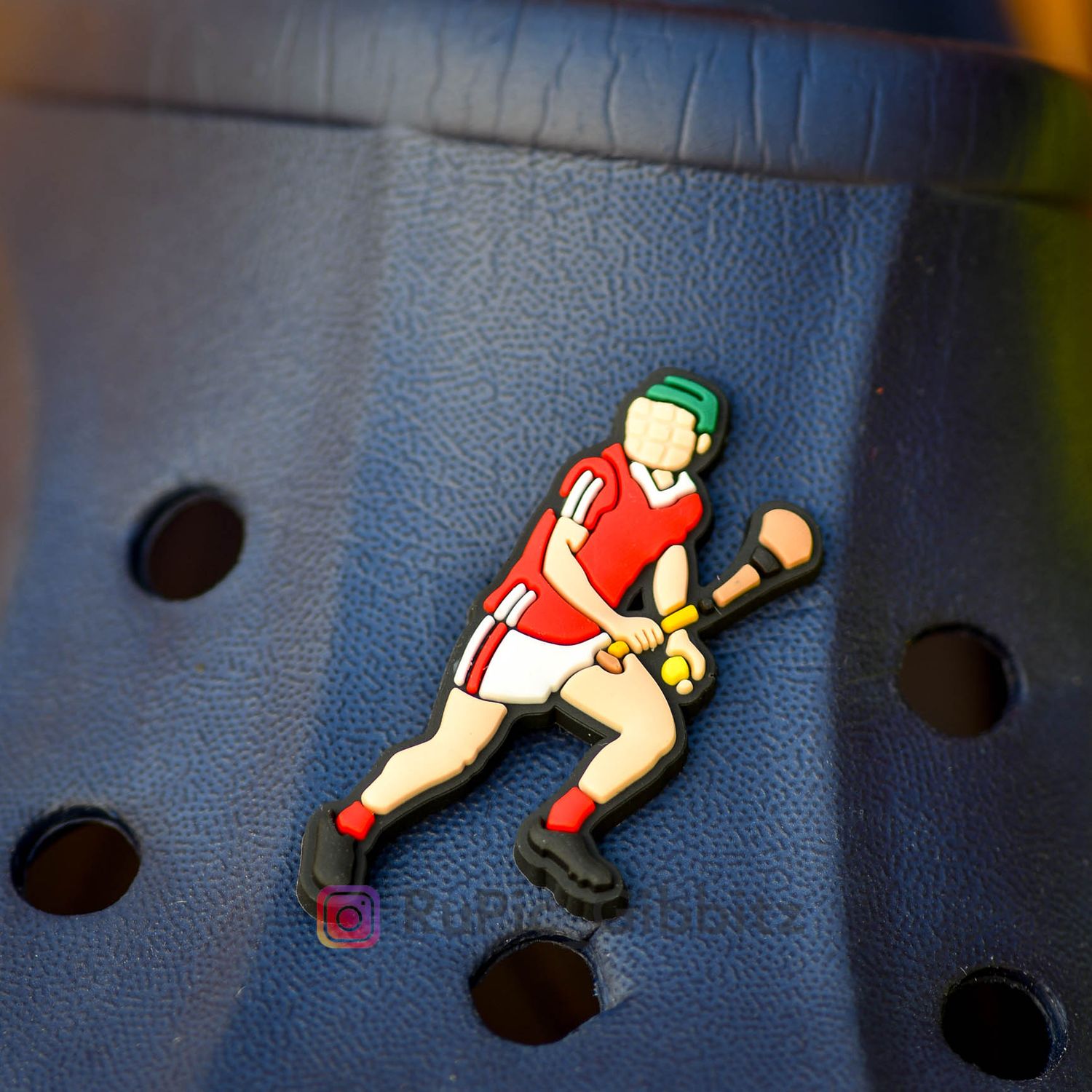 A hurling player looking for a pass in a Cork style kit