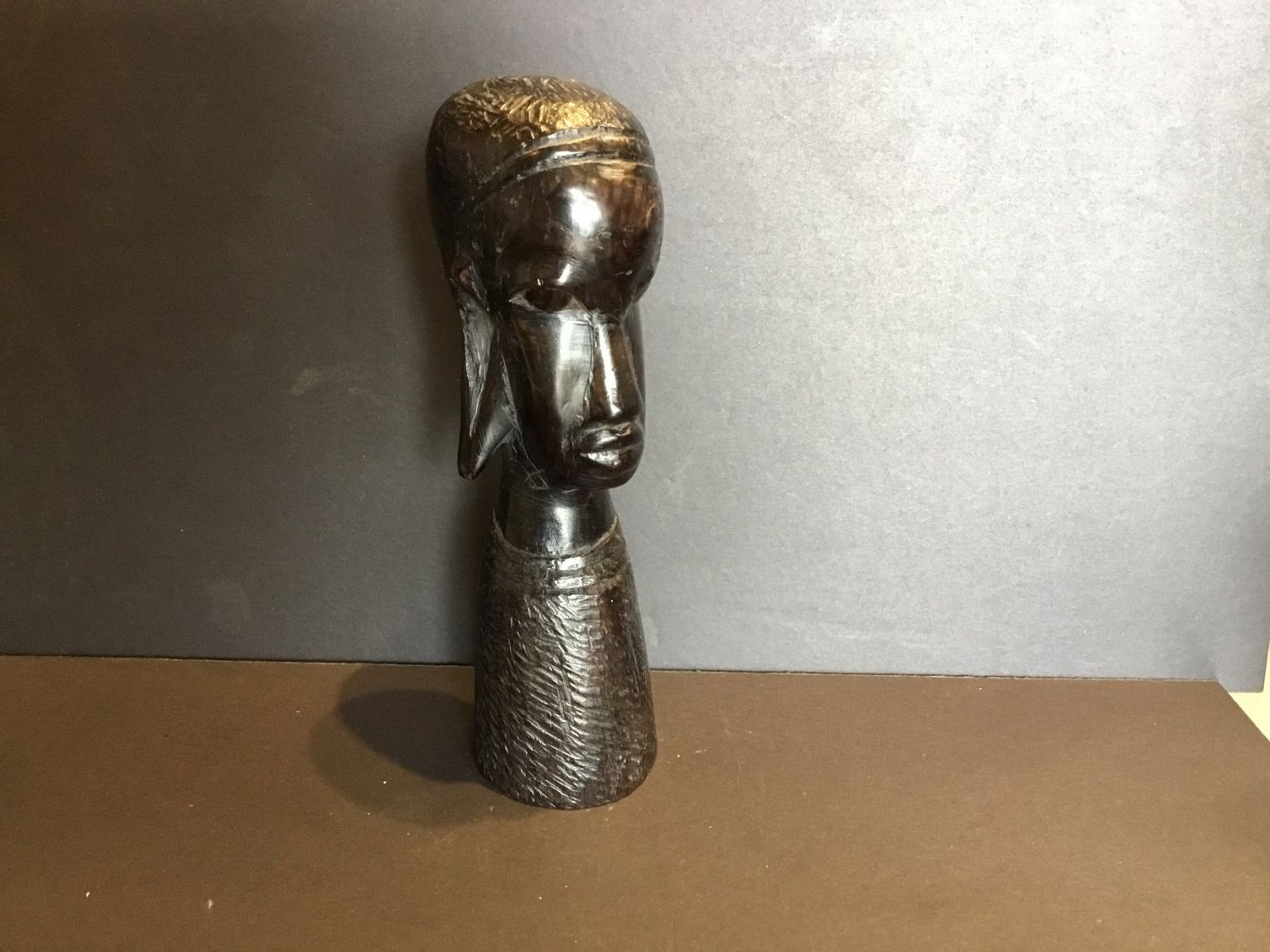 Carving of a mans head with stretched ears