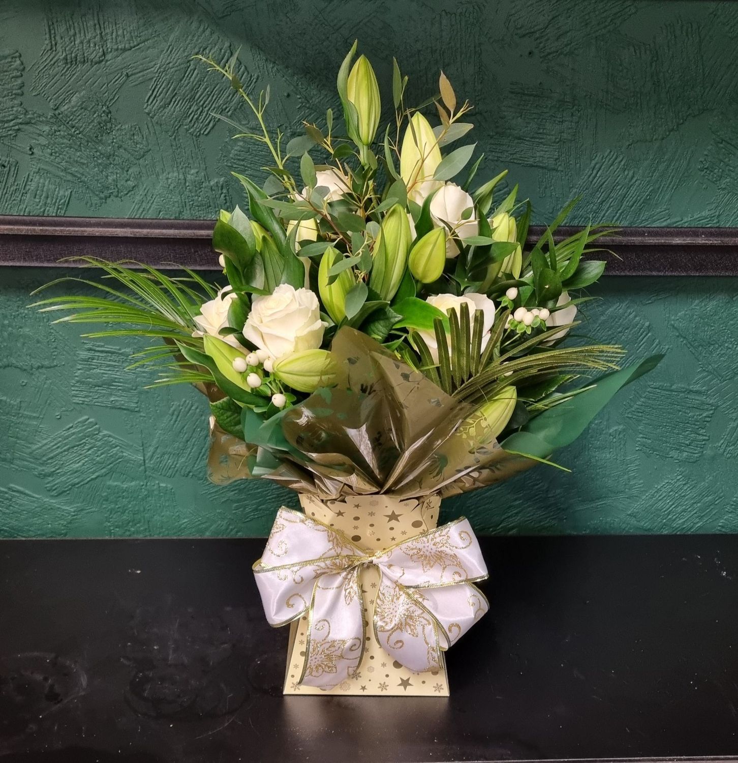 Christmas Aqua packed Lily and rose Bouquet with seasonal foliage for Local delivery starting from £60.00