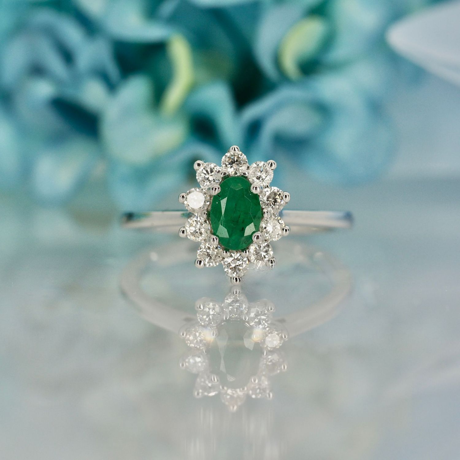Platinum Oval Cut Emerald & Round Brilliant Cut Diamond Cluster Ring