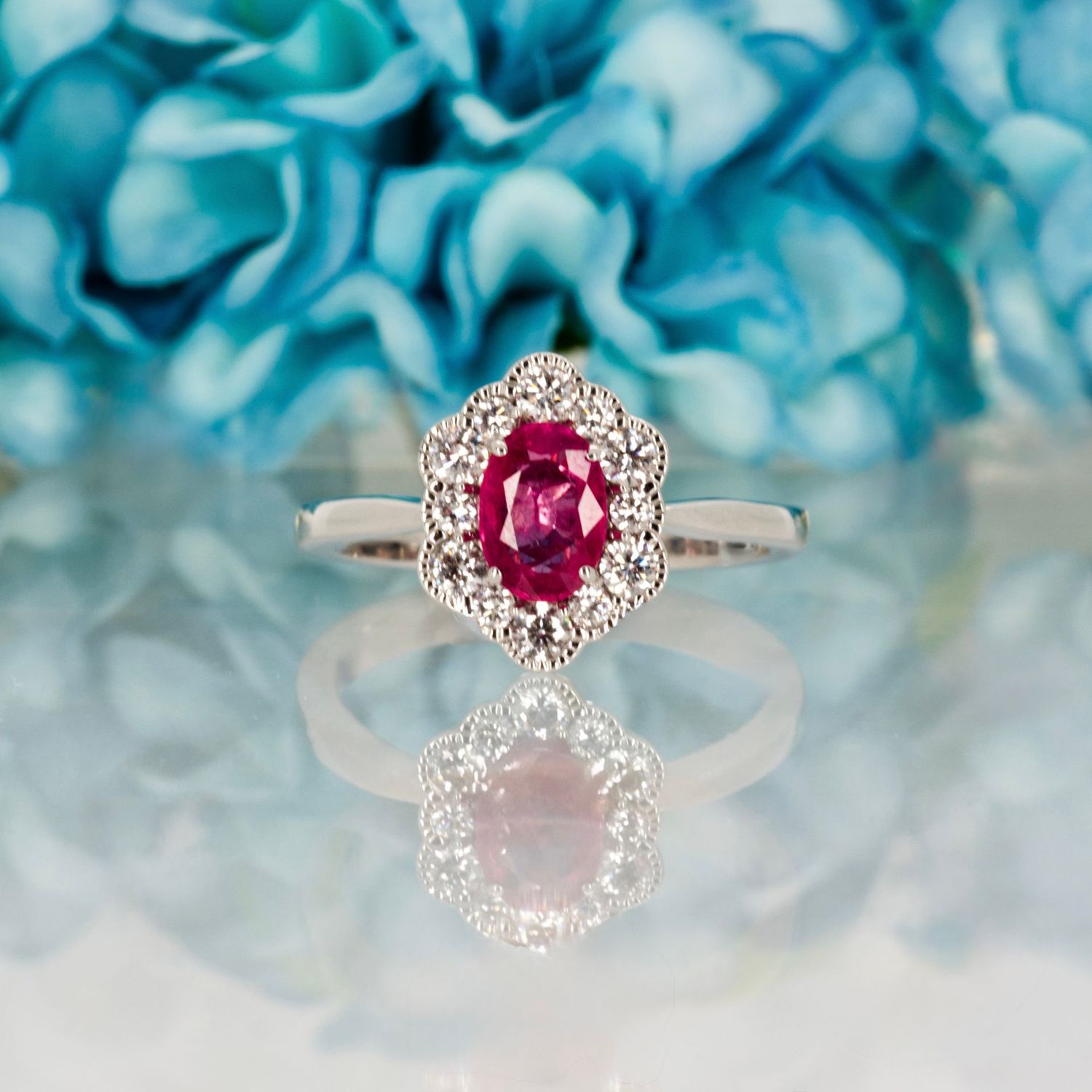 18ct White Gold Oval Cut Ruby & Round Brilliant Cut Diamond Cluster Ring