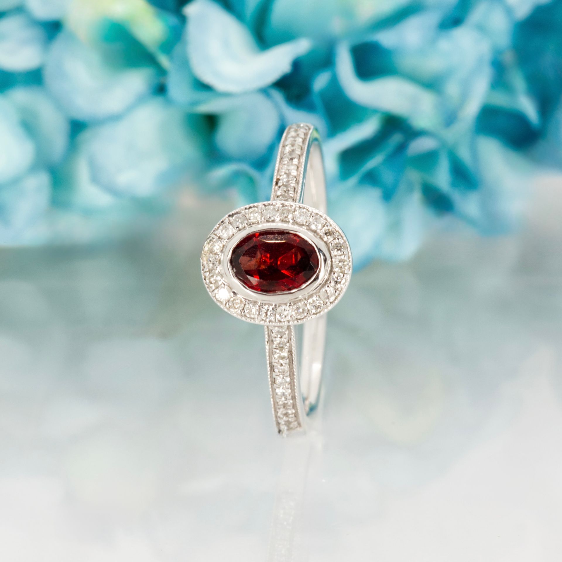 18ct White Gold Oval Cut Garnet & Round Brilliant Cut Diamond Halo Cluster Ring