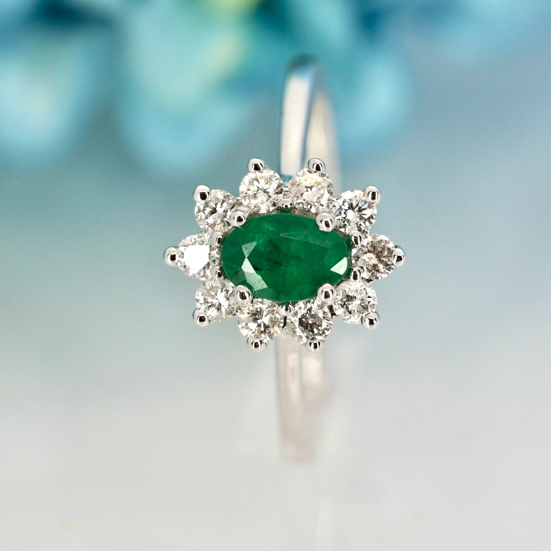 Platinum Oval Cut Emerald & Round Brilliant Cut Diamond Cluster Ring