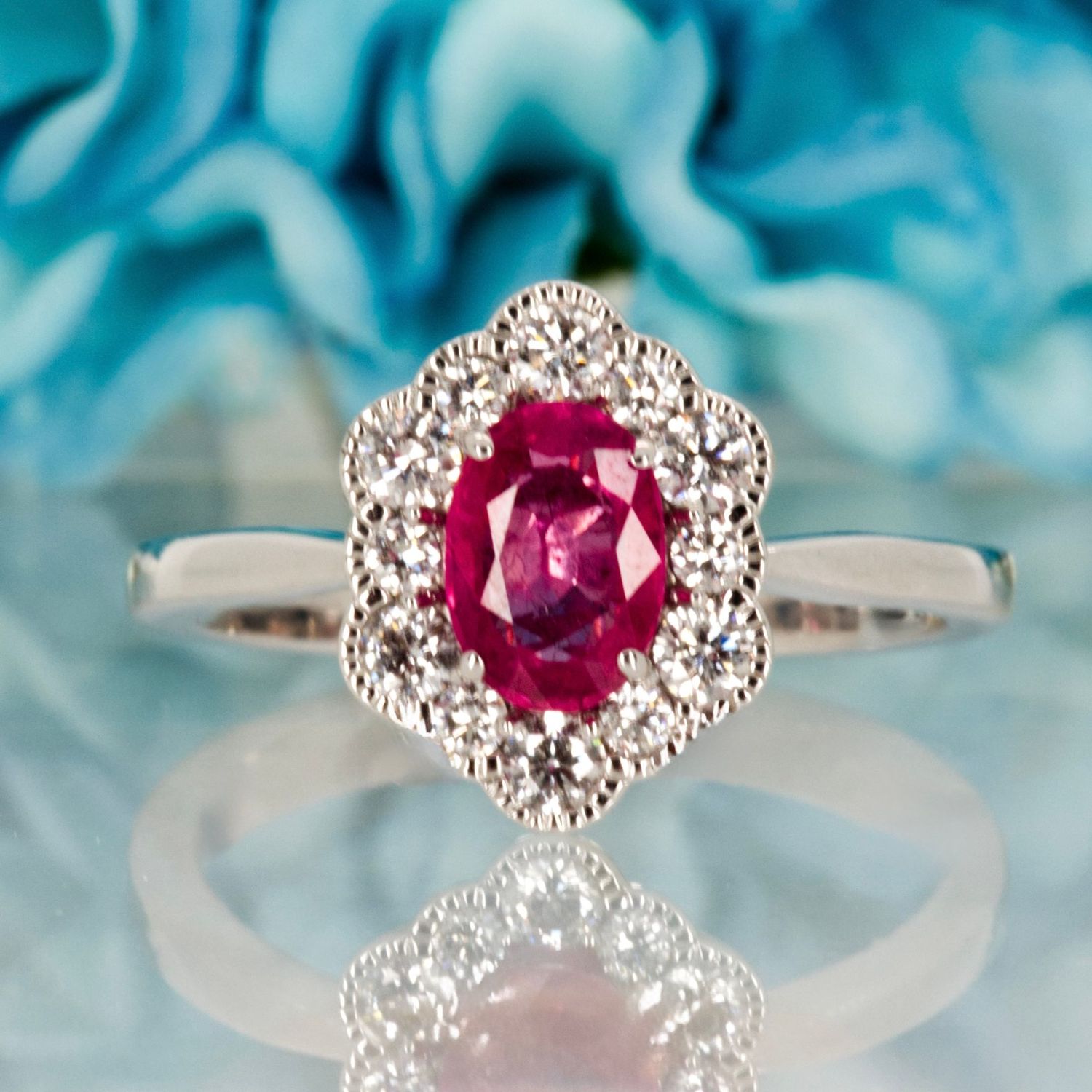 18ct White Gold Oval Cut Ruby & Round Brilliant Cut Diamond Cluster Ring