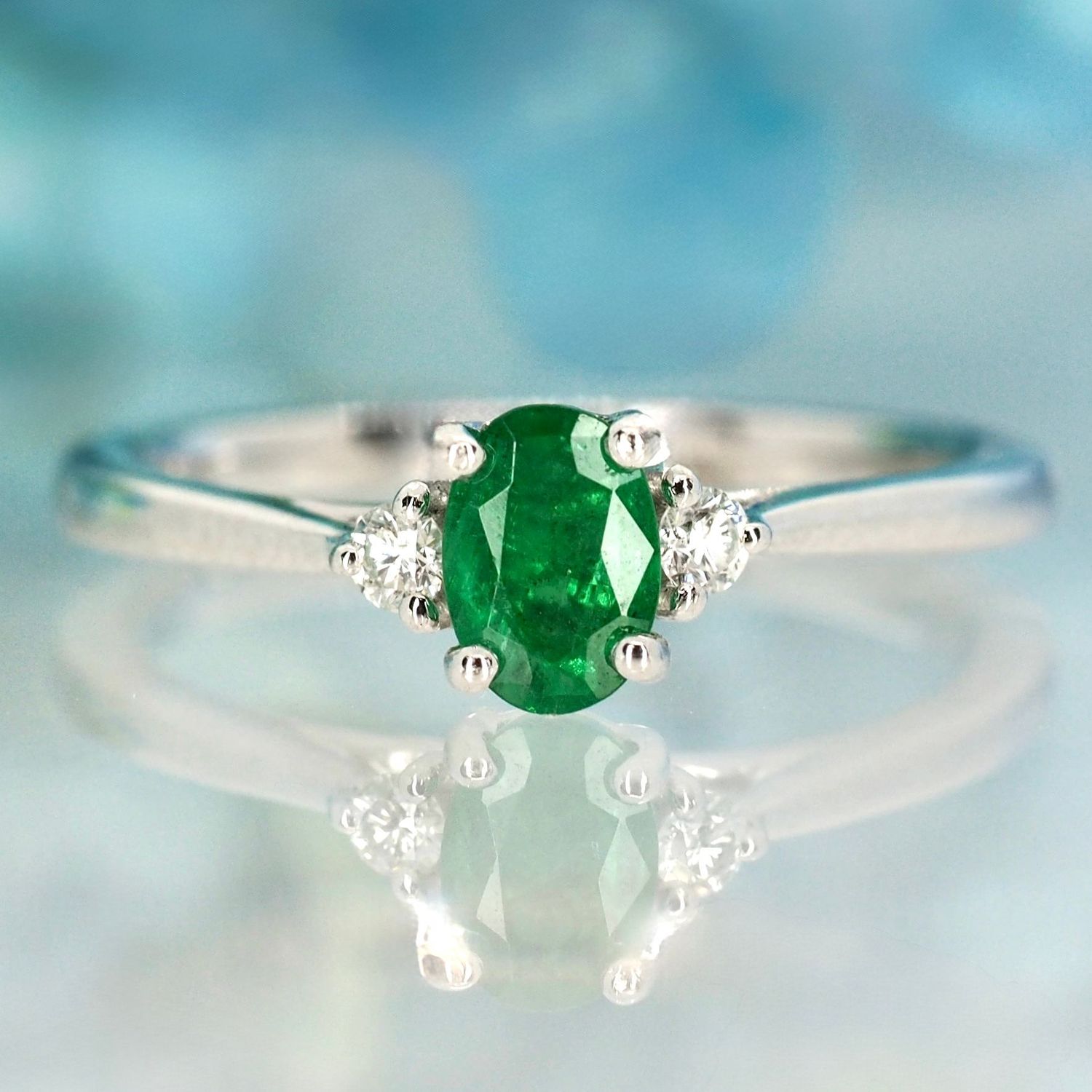 Platinum Oval Cut Emerald & Round Brilliant Cut Diamond Trilogy Ring