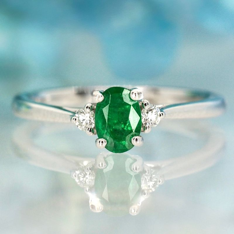 Platinum Oval Cut Emerald & Round Brilliant Cut Diamond Trilogy Ring