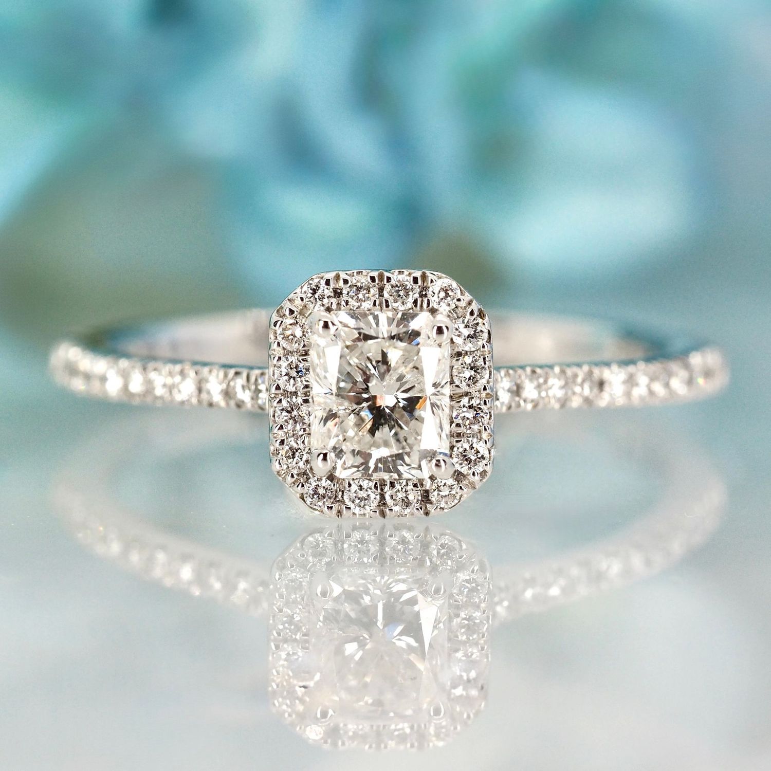 Platinum 0.70ct Emerald Cut & Round Brilliant Cut Diamond Halo Cluster Ring