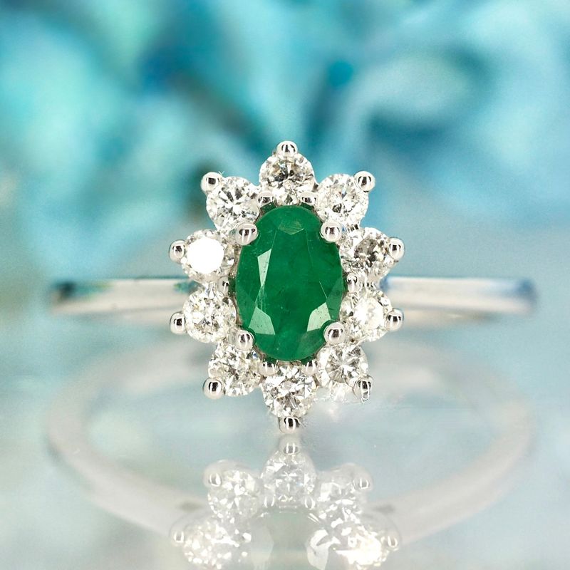 Platinum Oval Cut Emerald & Round Brilliant Cut Diamond Cluster Ring