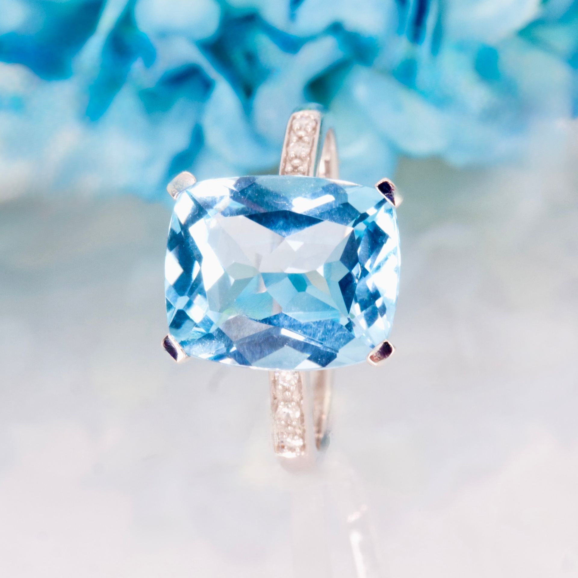 9ct White Gold Elongated Cushion Cut Blue Topaz & Round Brilliant Cut Diamond Ring