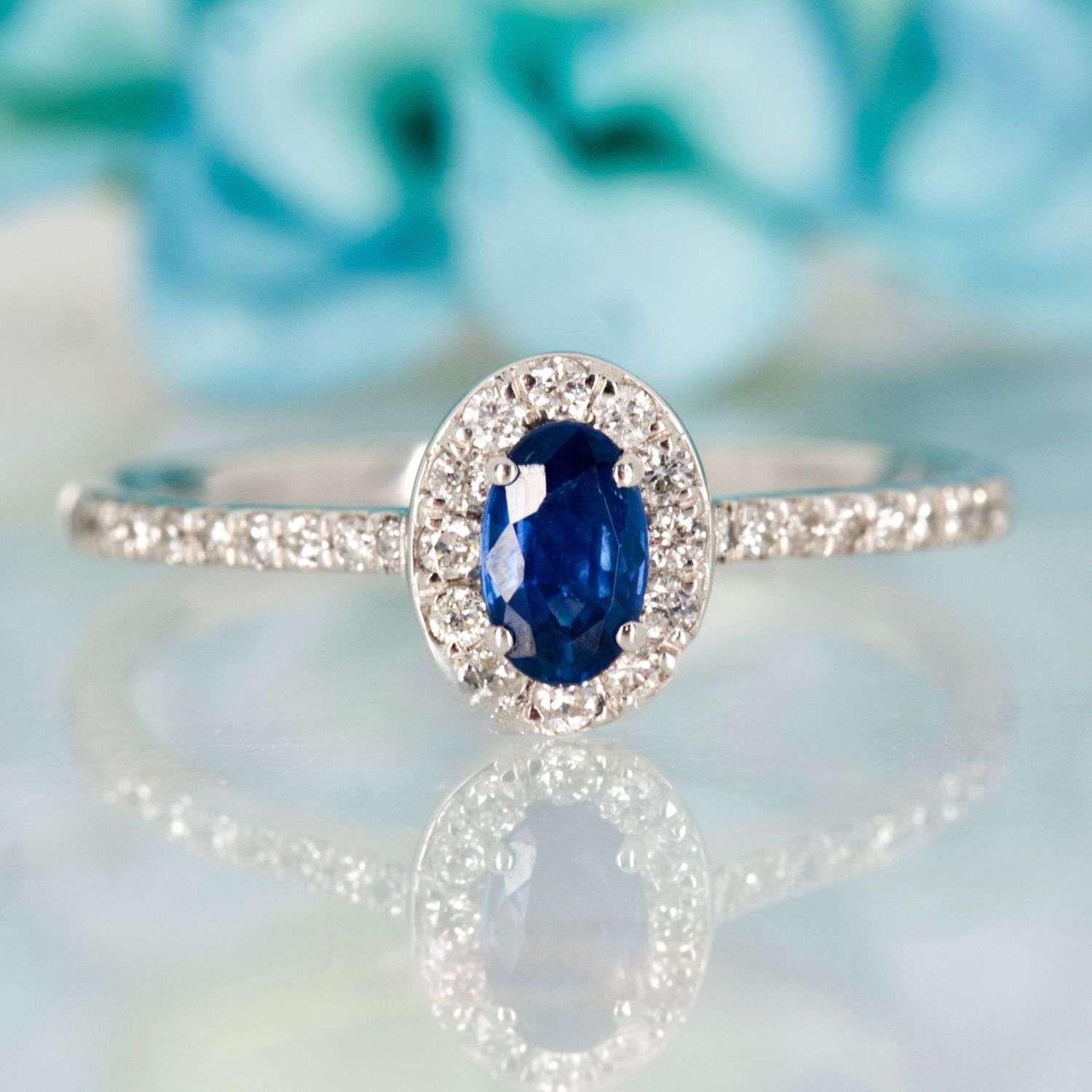Platinum Oval Cut Sapphire & Round Brilliant Cut Diamond Halo Cluster Ring