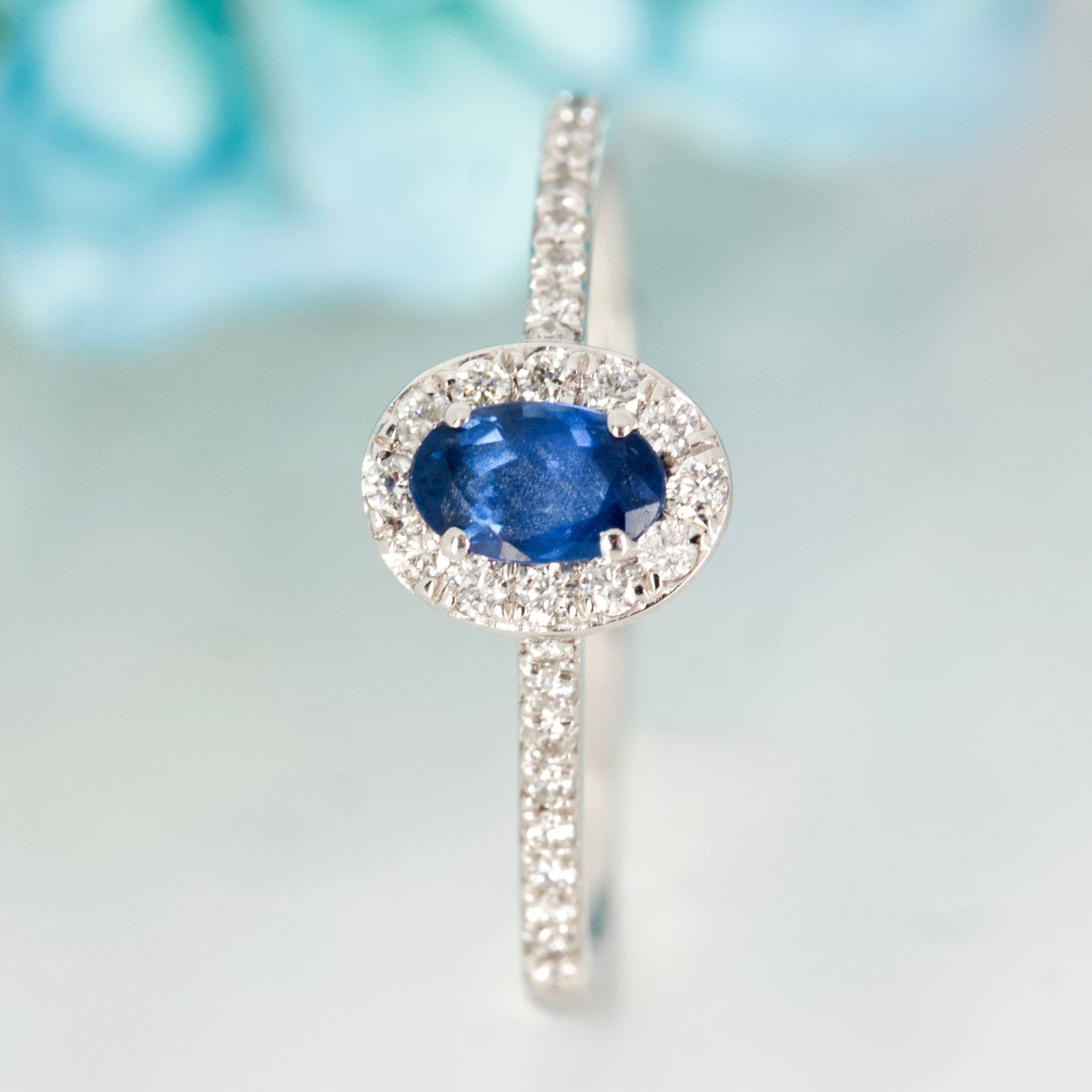 Platinum Oval Cut Sapphire & Round Brilliant Cut Diamond Halo Cluster Ring