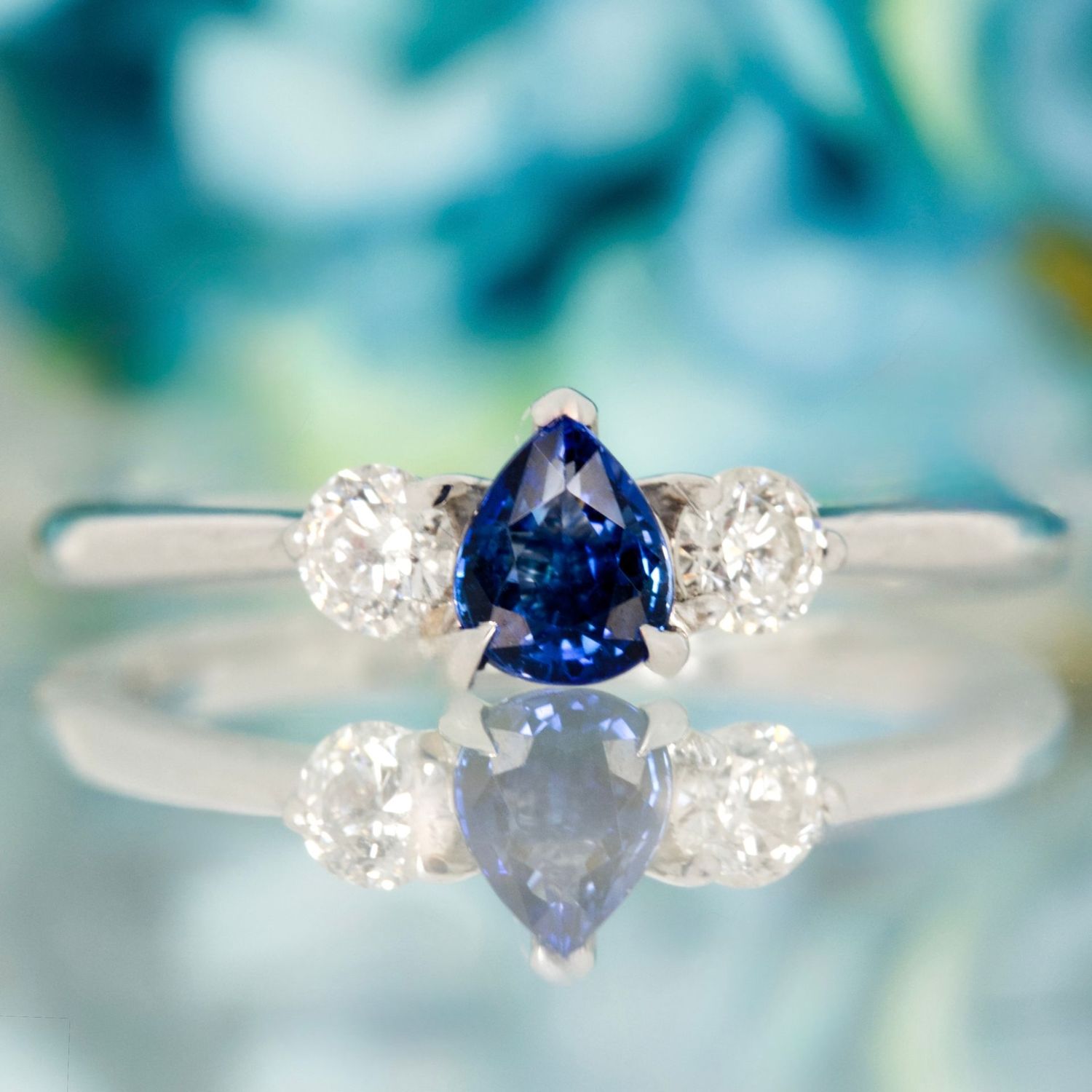 Platinum Pear Cut Sapphire & Round Brilliant Cut Diamond Trilogy Ring