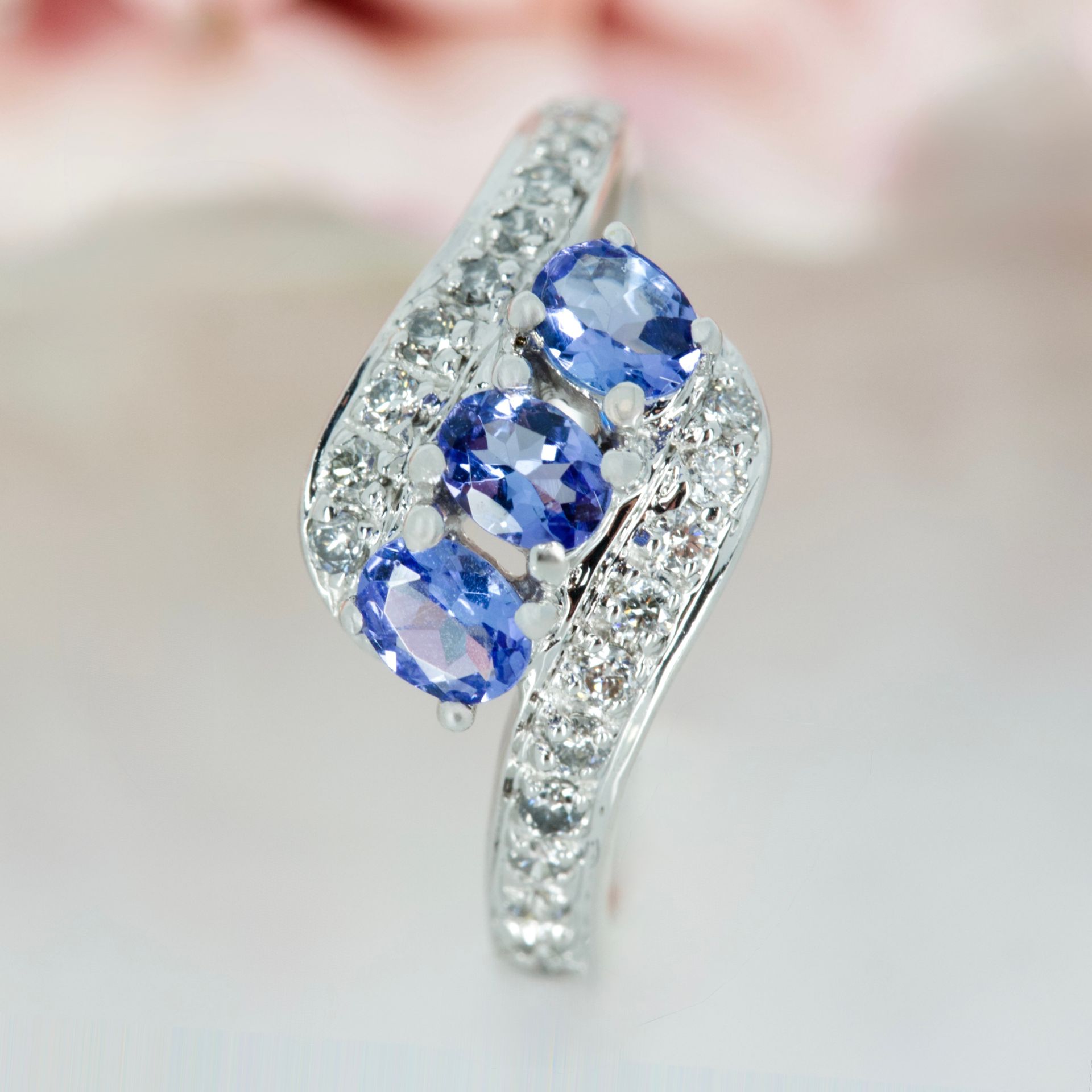 Pre-Loved 18ct White Gold Oval Cut Tanzanite & Round Brilliant Cut Diamond Twist Ring