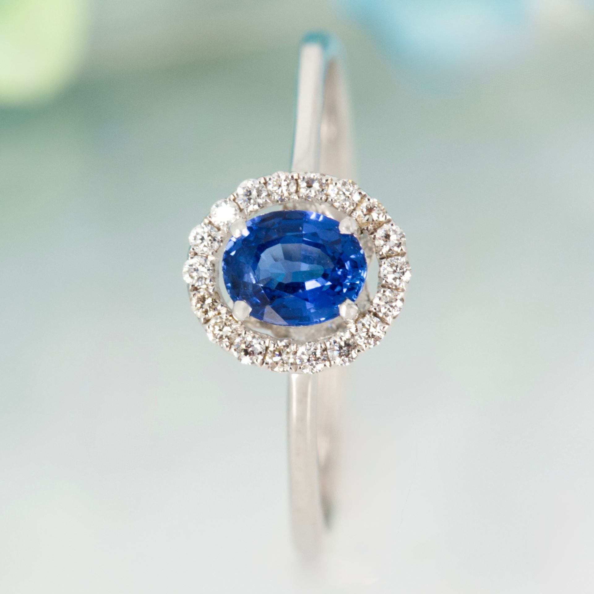 Pre-Loved 18ct White Gold Oval Cut Sapphire & Round Brilliant Cut Diamond Halo Cluster Ring