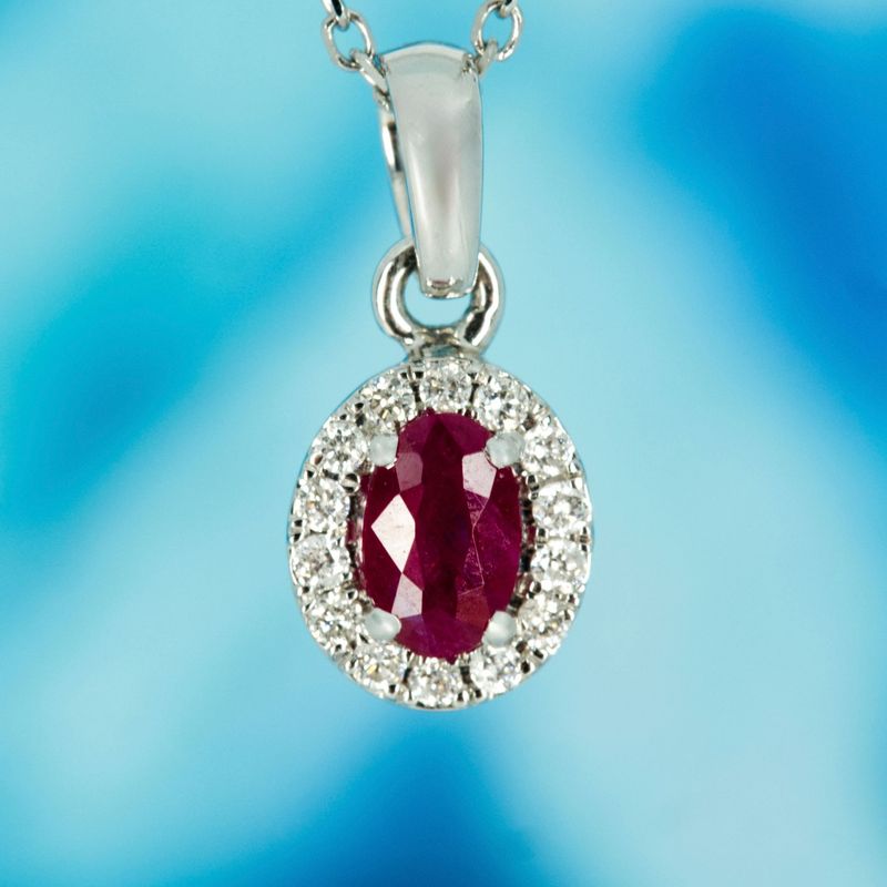 18ct White Gold Oval Cut Ruby & Round Brilliant Cut Diamond Halo Cluster Pendant & Chain