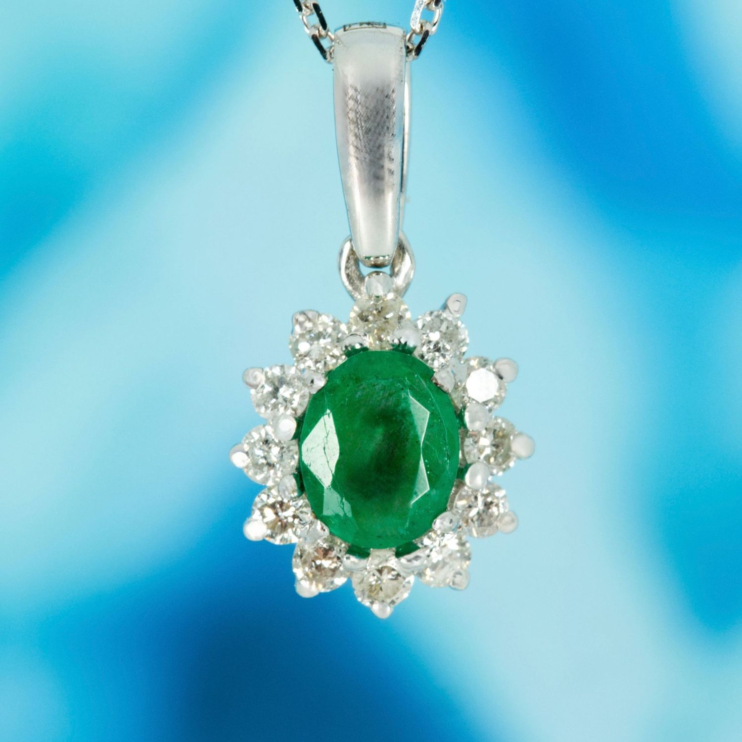 9ct White Gold Oval Cut Emerald & Round Brilliant Cut Diamond Cluster Pendant & Chain