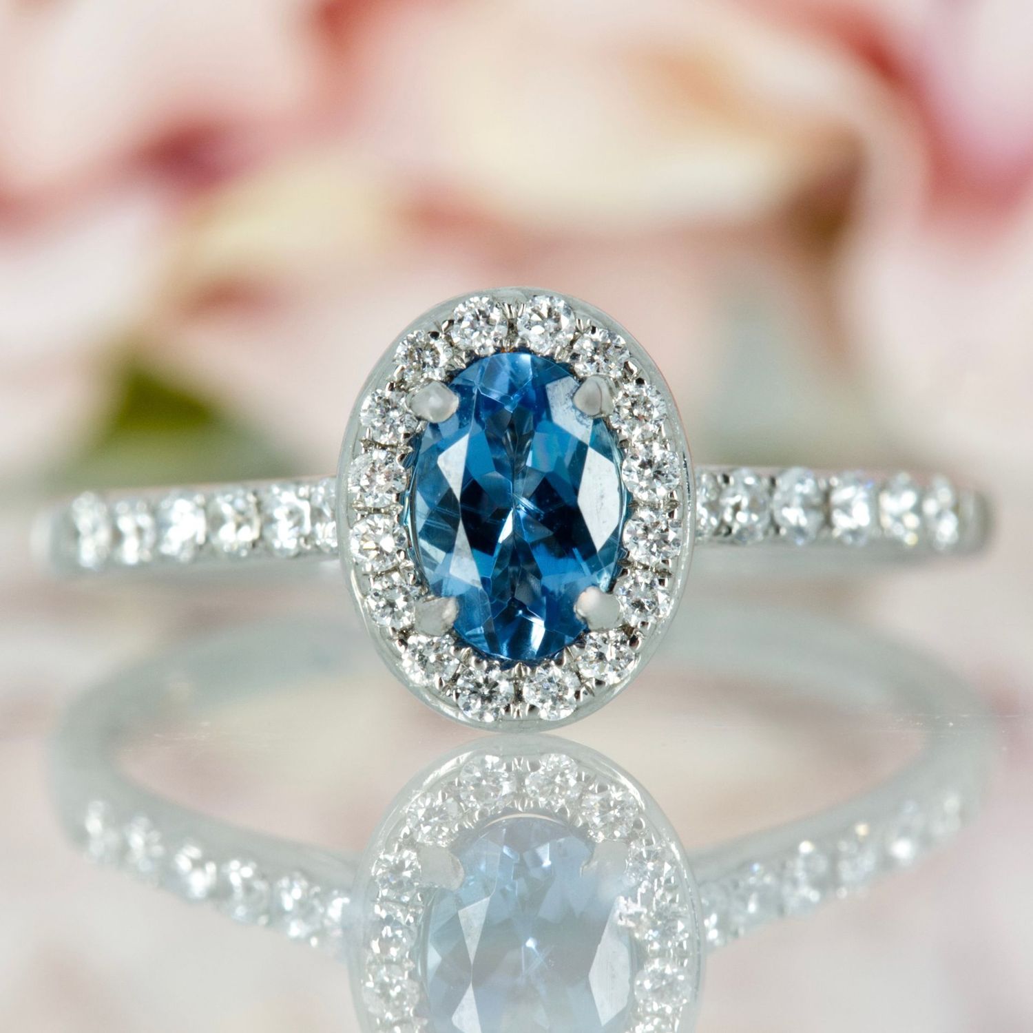 18ct White Gold Oval Cut Aquamarine & Round Brilliant Cut Diamond Halo Cluster Ring 18ct White Gold Oval Cut Aquamarine & Round Brilliant Cut Diamond Halo Cluster Ring