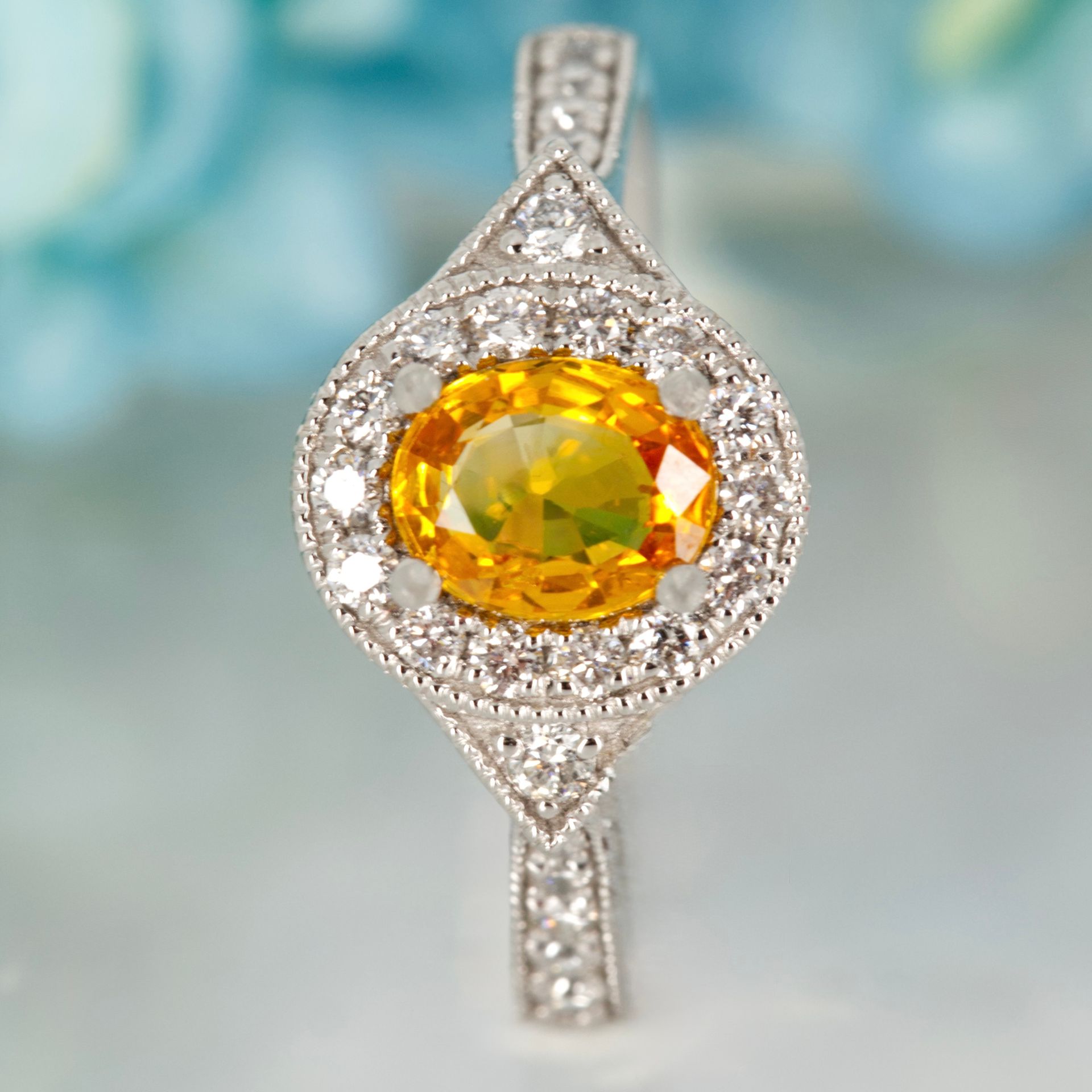 Platinum Oval Cut Sapphire & Round Brilliant Cut Diamond Halo Cluster Ring