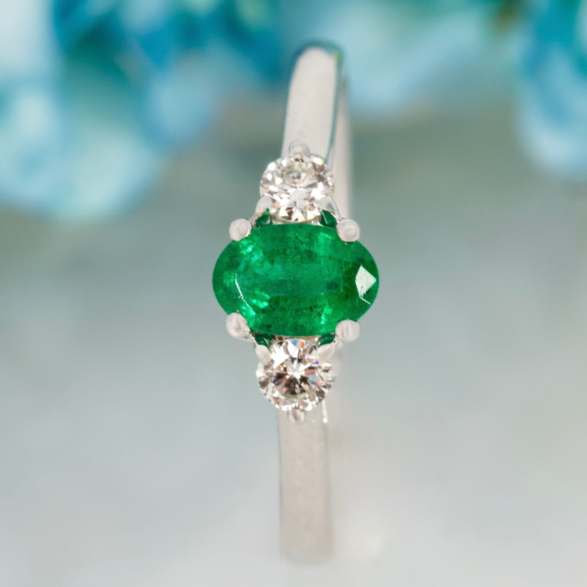 Platinum Oval Cut Emerald & Round Brilliant Cut Diamond Trilogy Ring