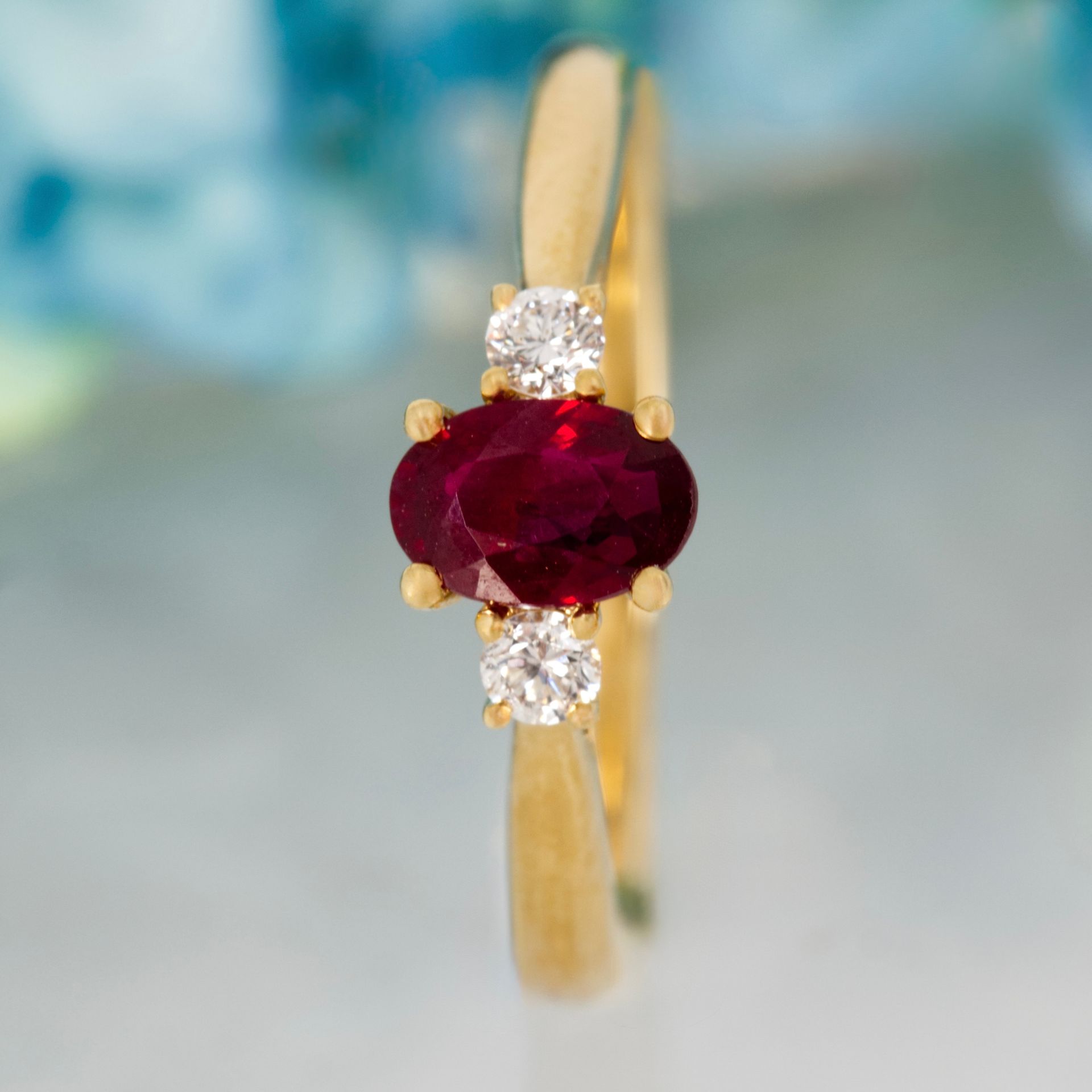 18ct Yellow Gold Oval Cut Ruby & Round Brilliant Cut Diamond Trilogy Ring