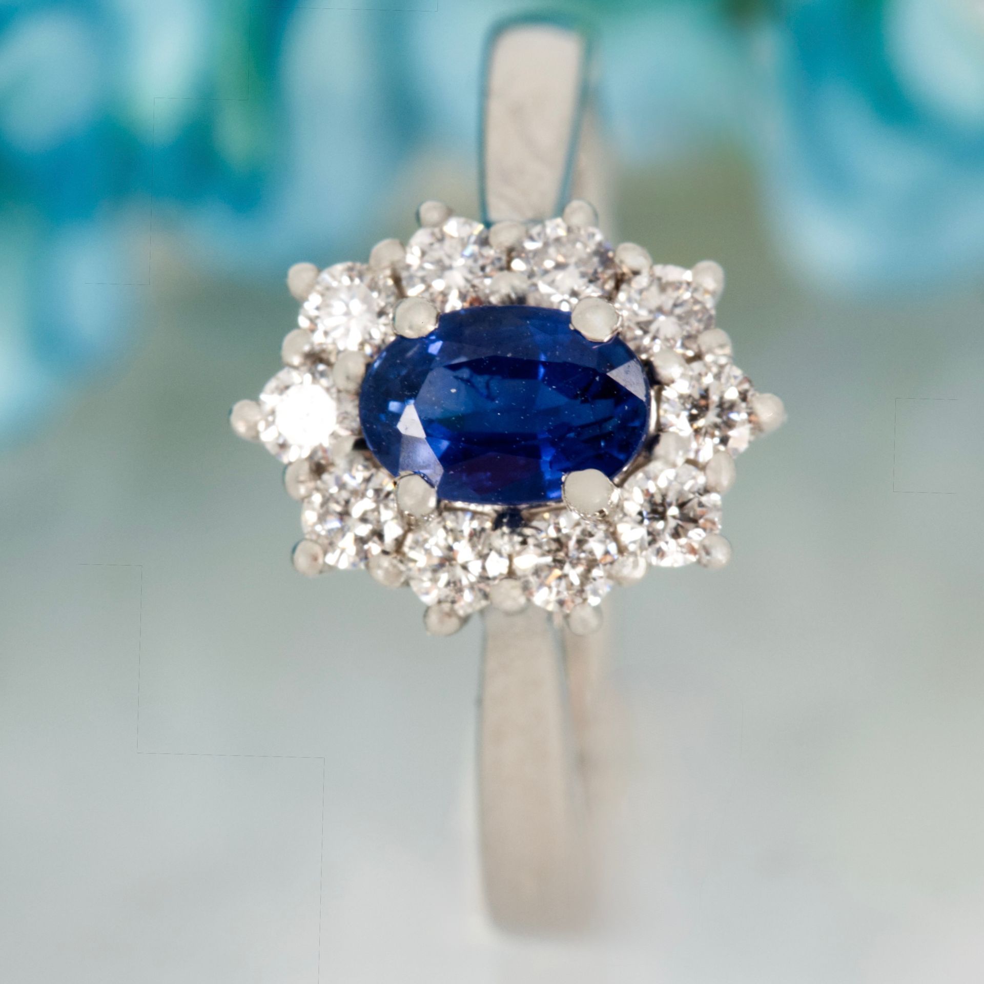 Platinum Oval Cut Sapphire & Round Brilliant Cut Diamond Cluster Ring