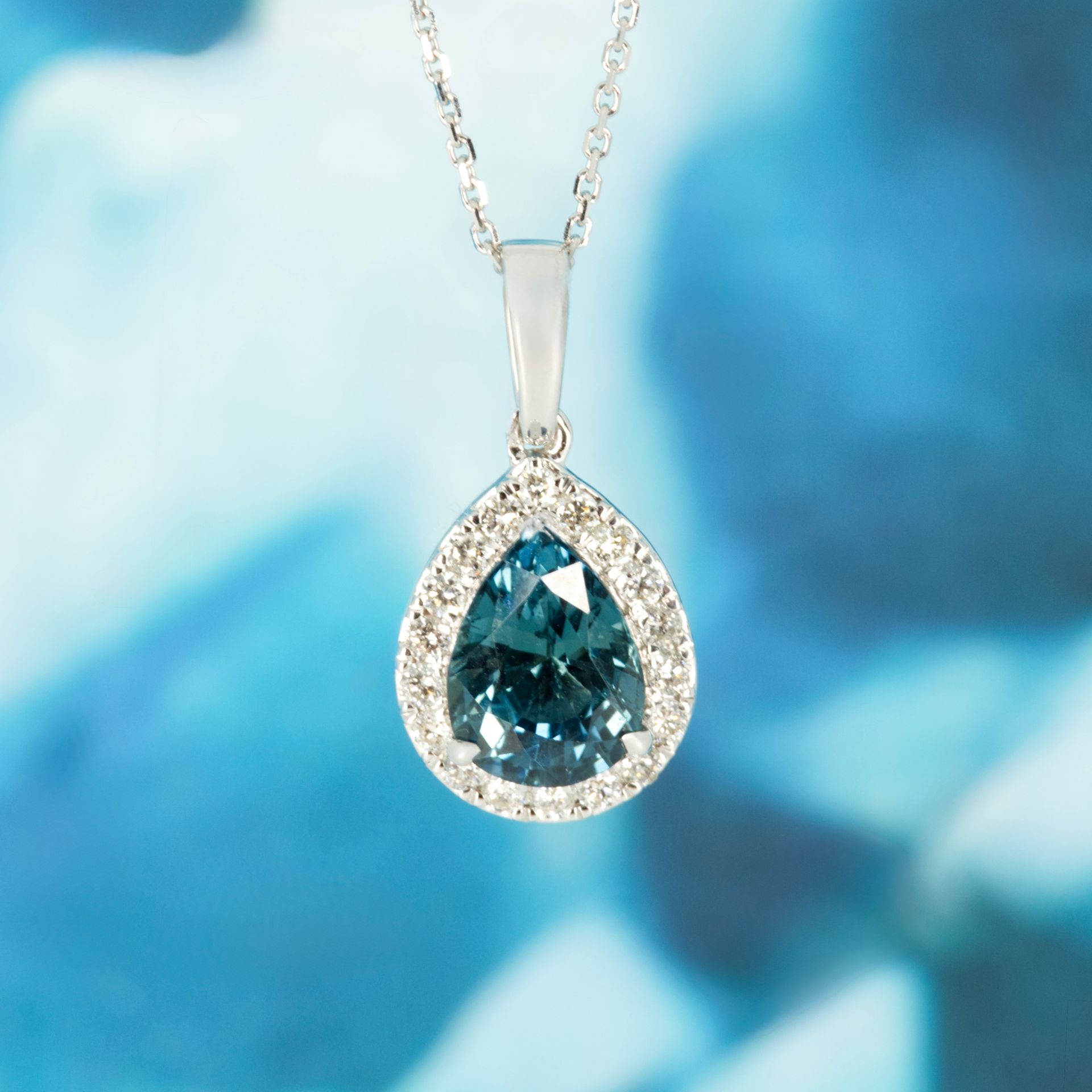 9ct White Gold Pear Cut Teal Sapphire & Round Brilliant Cut Diamond Halo Cluster Pendant & Chain