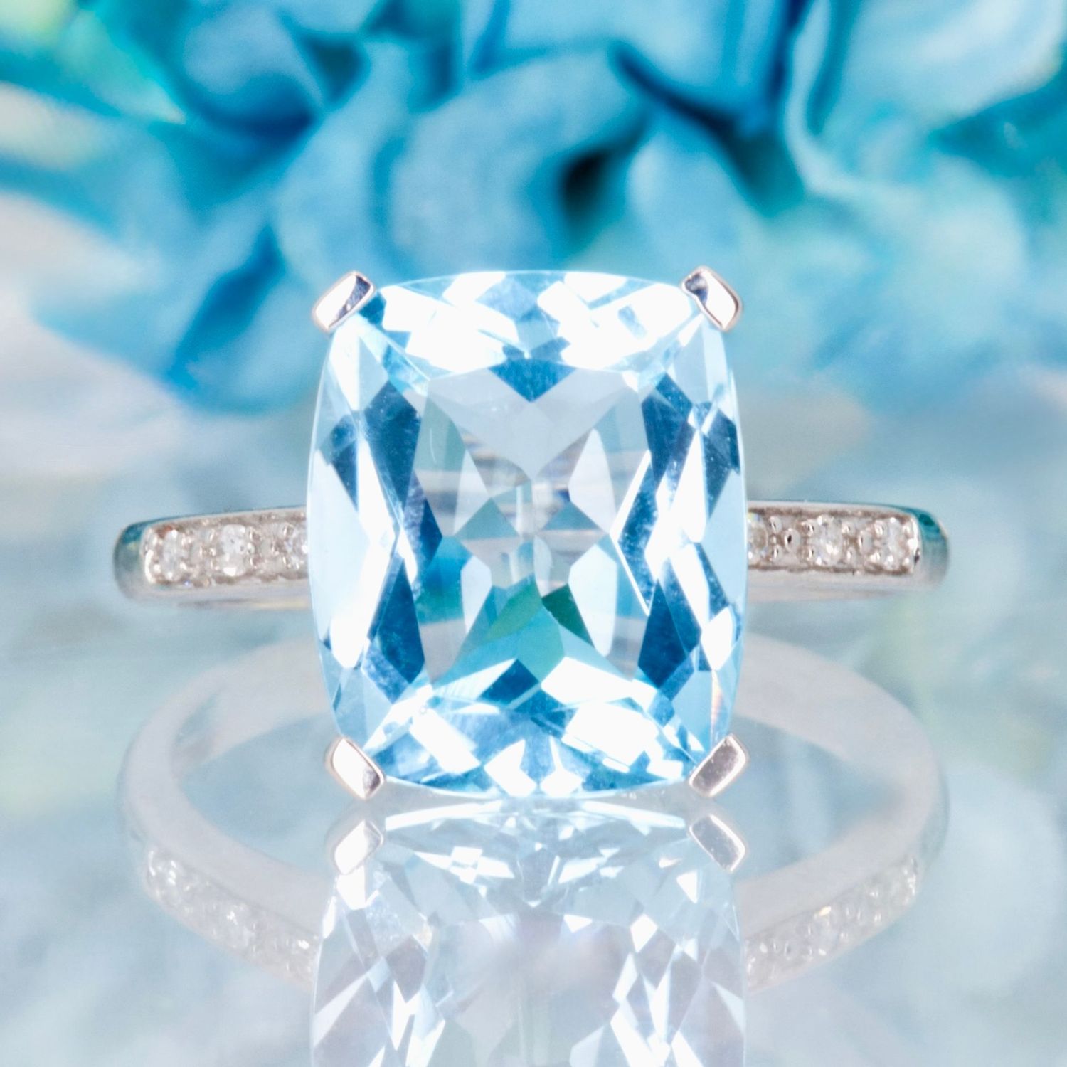9ct White Gold Elongated Cushion Cut Blue Topaz & Round Brilliant Cut Diamond Ring