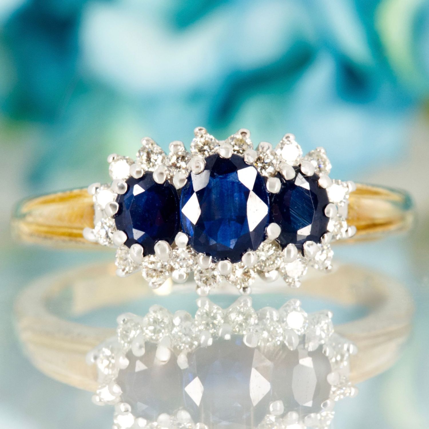 9ct Yellow Gold Oval Cut Sapphire & Round Brilliant Cut Diamond Triple Cluster Ring 9ct Yellow Gold Oval Cut Sapphire & Round Brilliant Cut Diamond Triple Cluster Ring