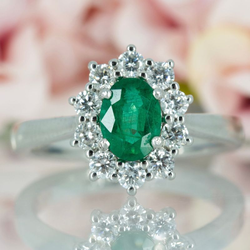 Platinum Oval Cut Emerald & Round Brilliant Cut Diamond Cluster Ring