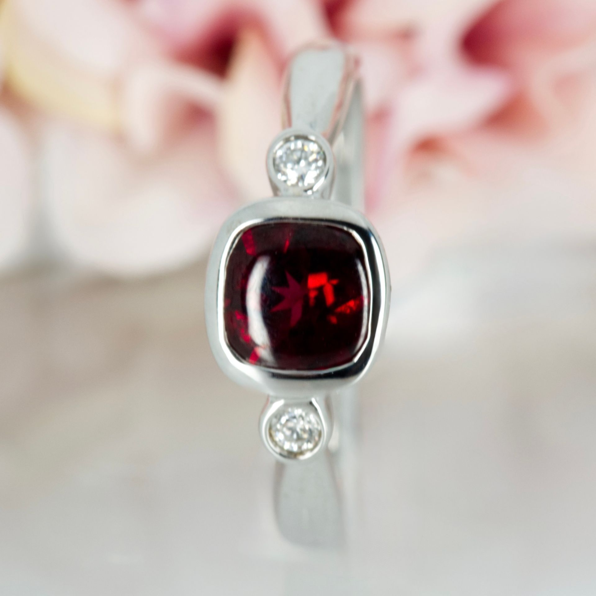 Pre-Loved 18ct White Gold Cushion Cut Garnet & Round Brilliant Cut Diamond Trilogy Ring