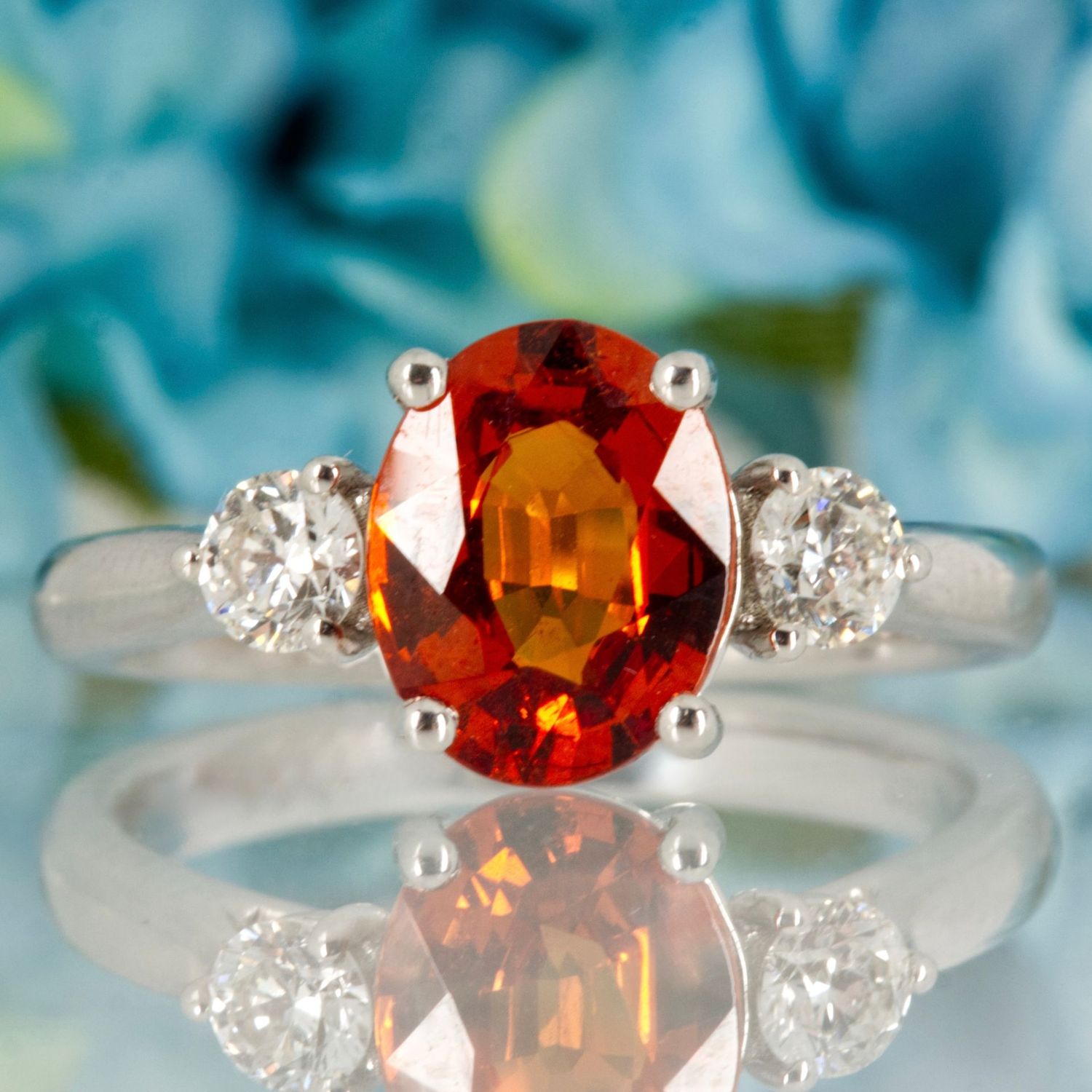 Platinum Oval Cut Mandarin Garnet & Round Brilliant Cut Diamond Trilogy Ring